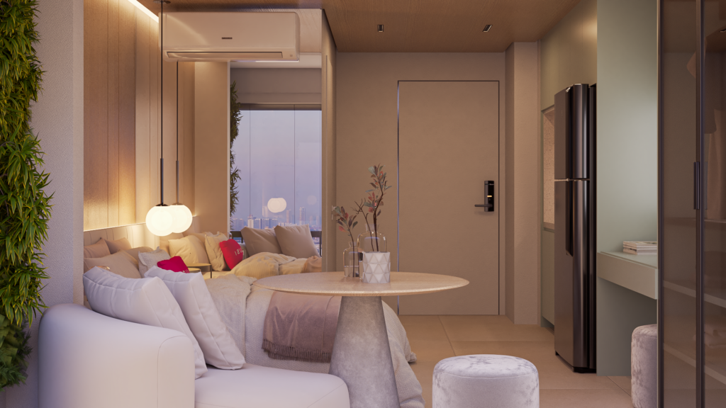 Studio decorado com sofá branco, mesa redonda e cozinha integrada, exemplo de decoração de apartamento pequeno em São Paulo